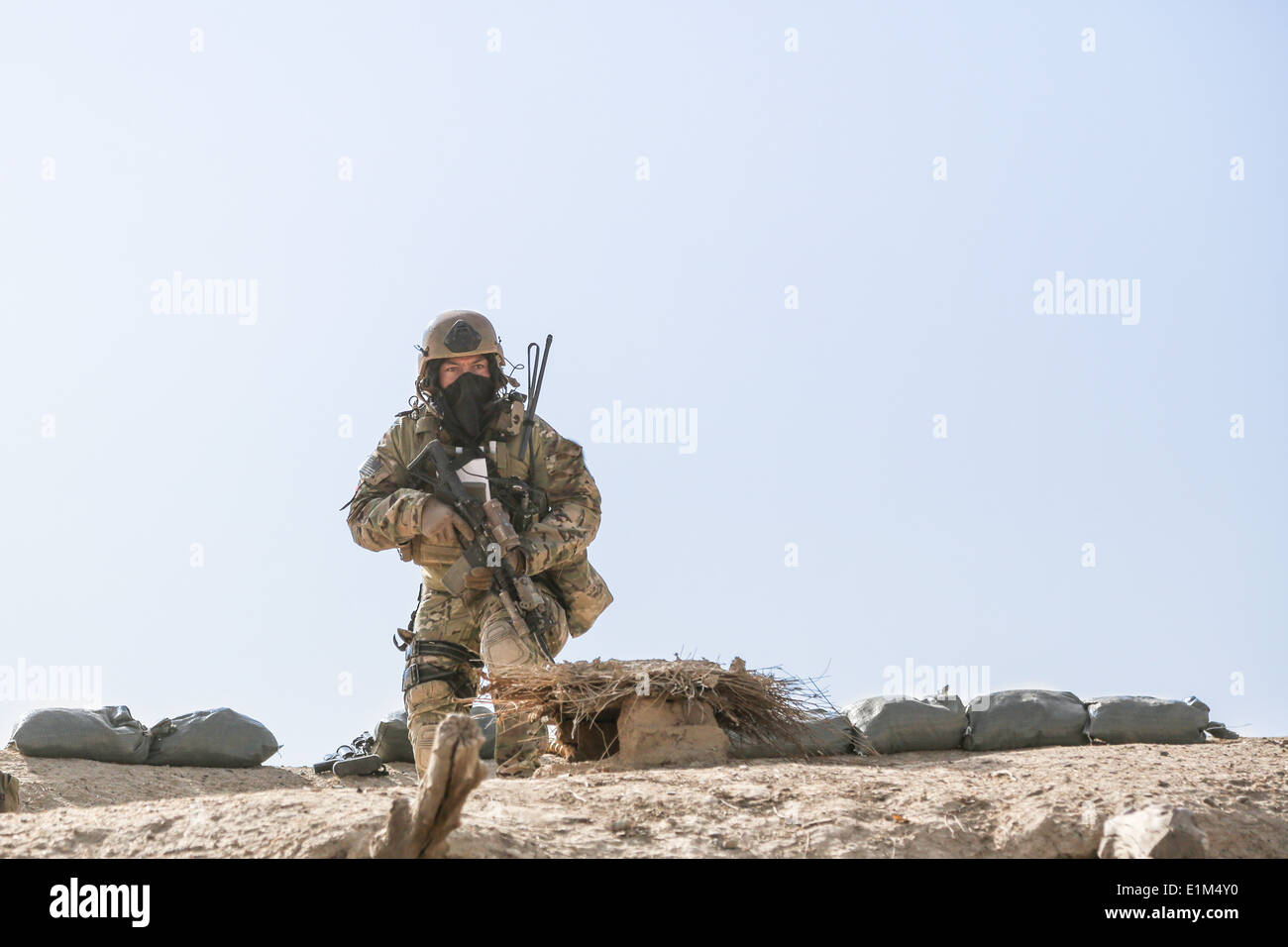 A U.S. Army Special Forces Soldier with Combined Joint Special Operations Task Force-Afghanistan moves across the rooftop of a Stock Photo