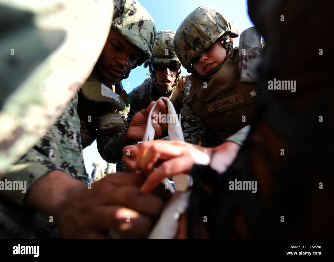 U.S. Navy Seabees from Naval Mobile Construction Battalion (NMCB) 3 demonstrate proper care under fire techniques during a mass Stock Photo