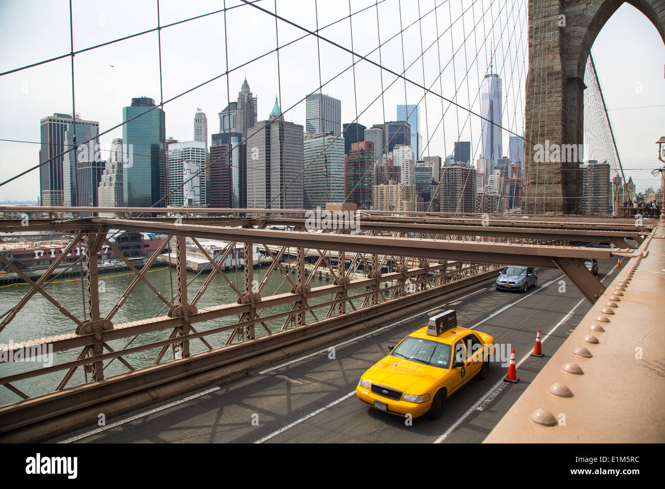 A Taxi Cab travelling over Brooklyn Bridge, NYC Stock Photo