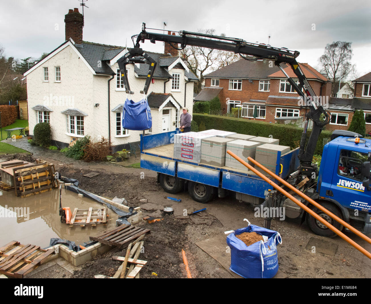 self building house, delivery of building materials being lifted from builder’s merchant’s lorry Stock Photo
