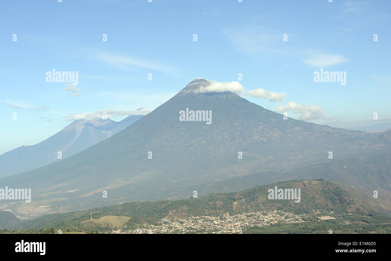 View from Mirador Majahue on  the slopes of Volcan de Pacaya. The town of San Vicente Pacaya lies below Volcan de Agua. Stock Photo