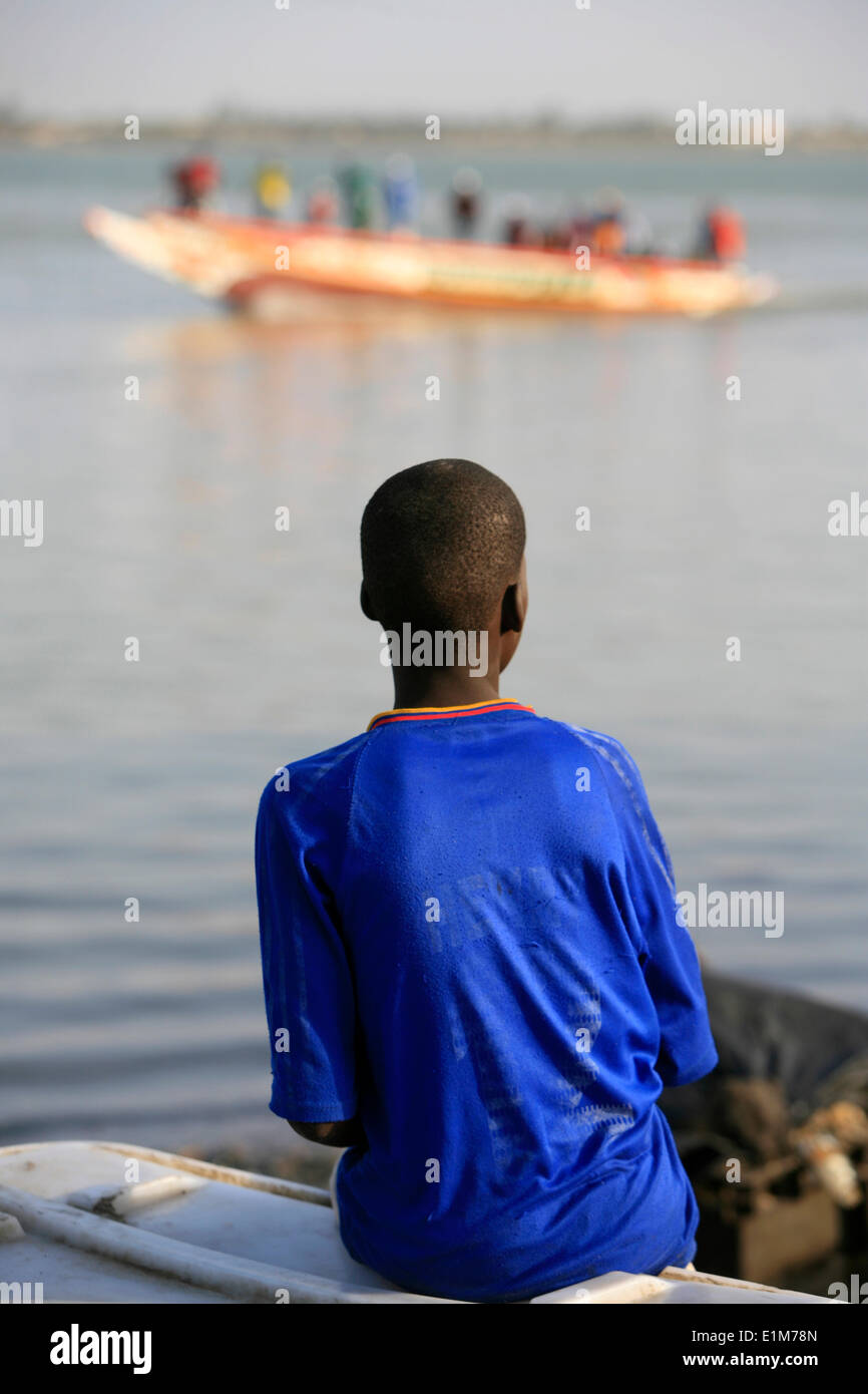 Boy facing the ocean Stock Photo