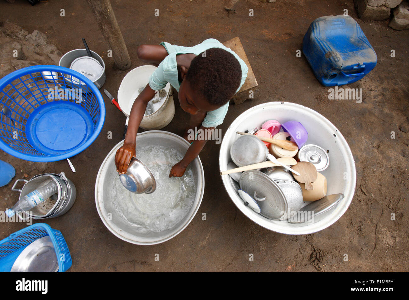 Child washing dishes Stock Photo