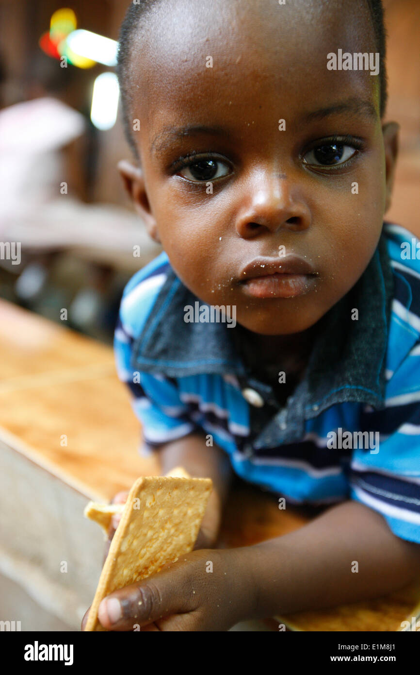 African boy eating a biscuit Stock Photo
