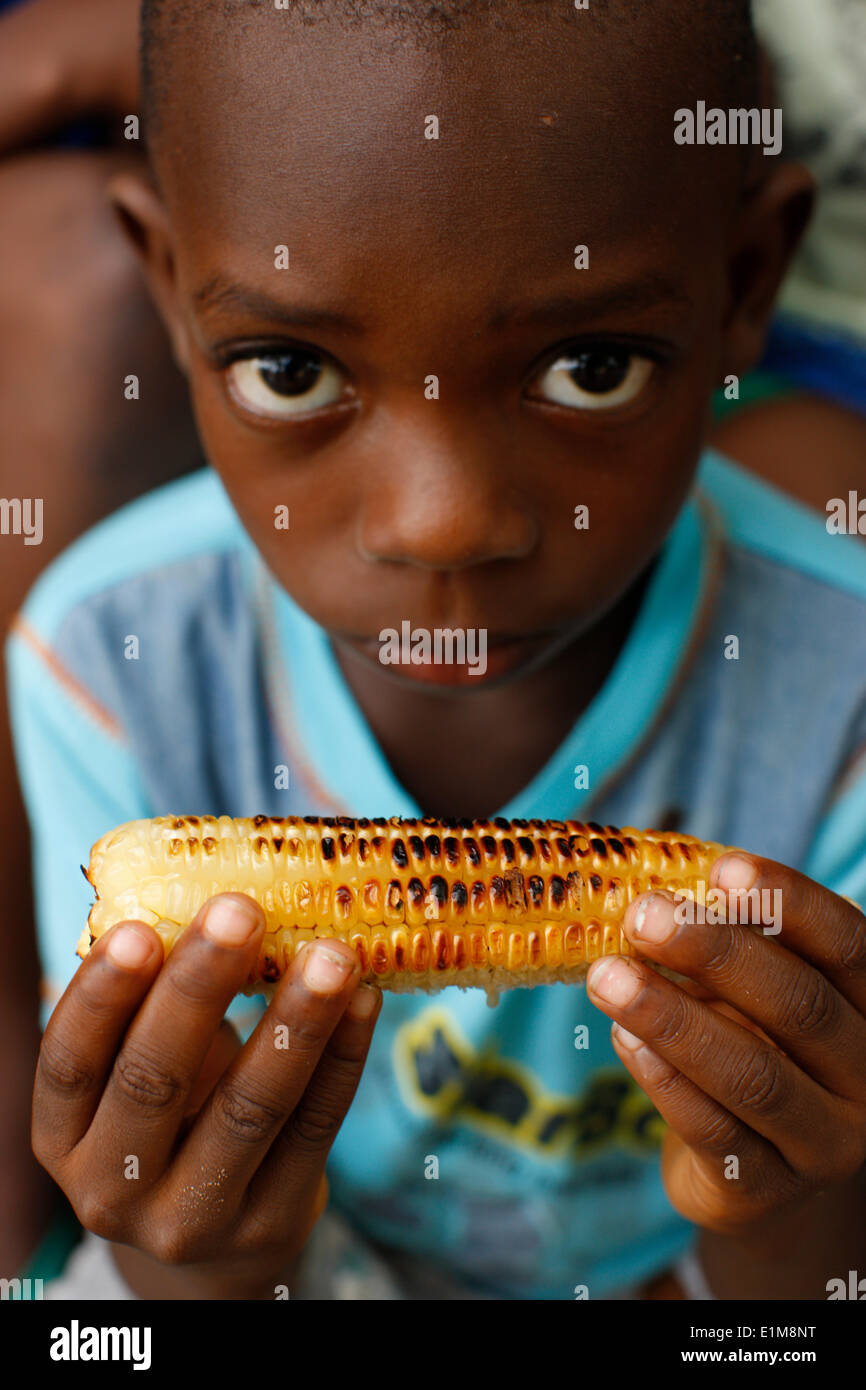 african-boy-eating-corn-stock-photo-alamy