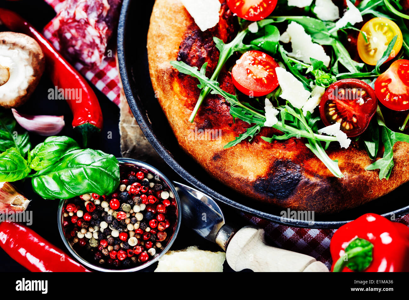 pizza and fresh italian ingredients on a dark background Stock Photo