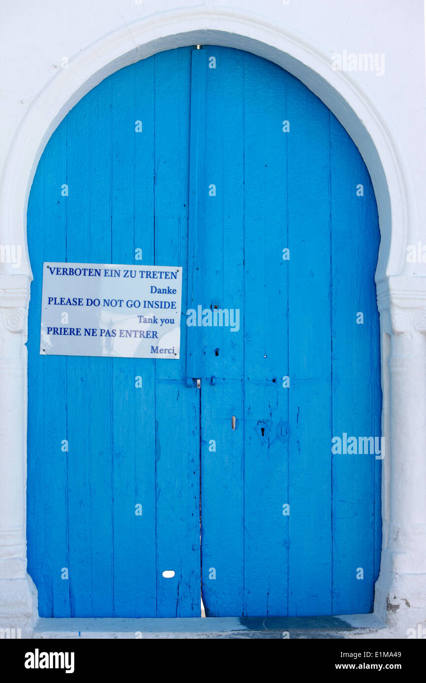 Mosque door with a no entry sign for foreigners Stock Photo
