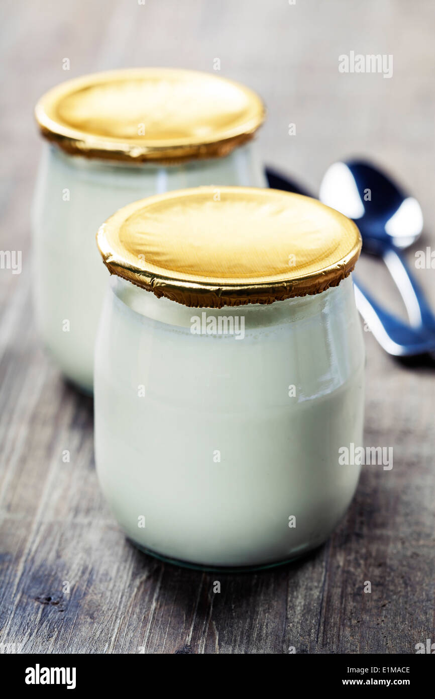 Sour cream or natural yogurt with spoons - health and diet concept Stock Photo
