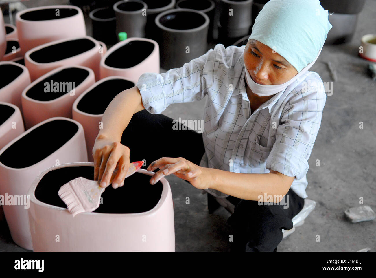 Woman working in a pottery factory Stock Photo - Alamy