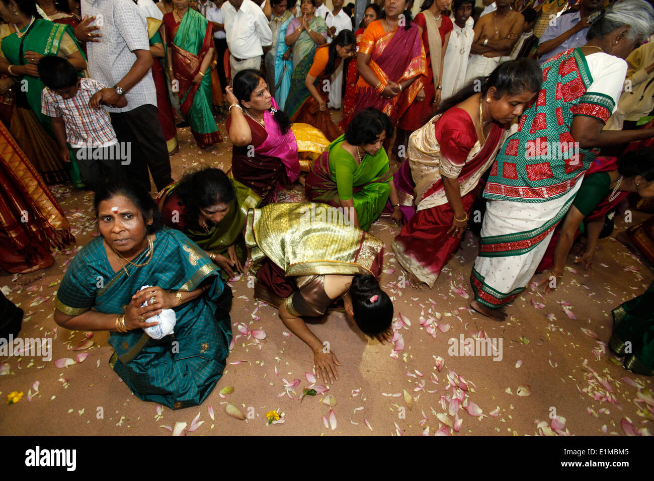 Tamil women prosternating at festival in Hindu temple Stock Photo