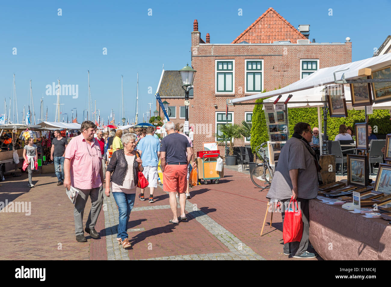 URK, THE NETHERLANDS - MAY 31: Tourists visiting a local fare during the fishing days of Urk on May 31, 2014 at the harbor of Ur Stock Photo