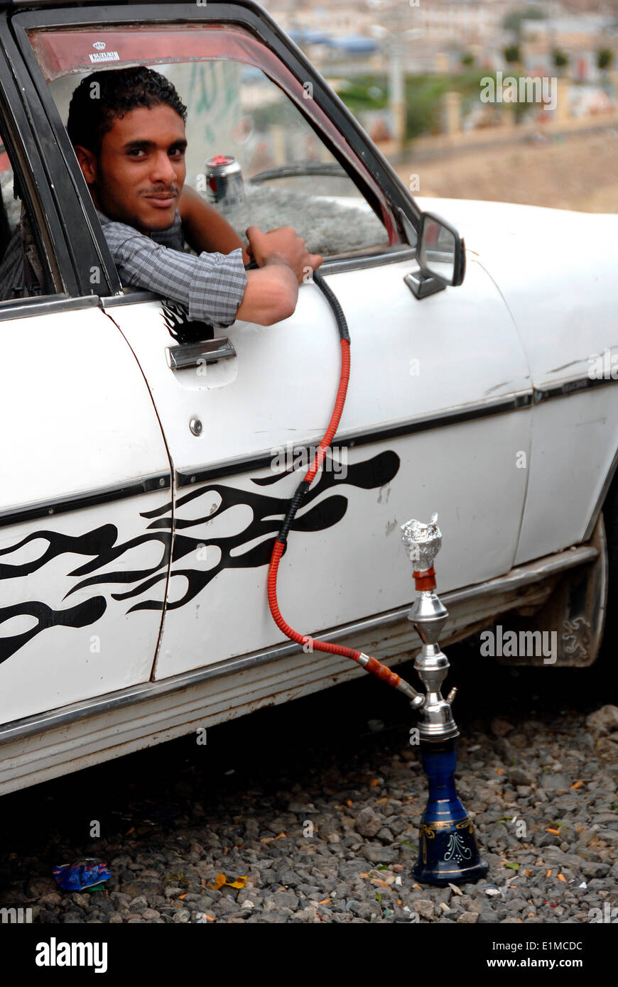 Driver smoking from a water pipe Stock Photo Alamy