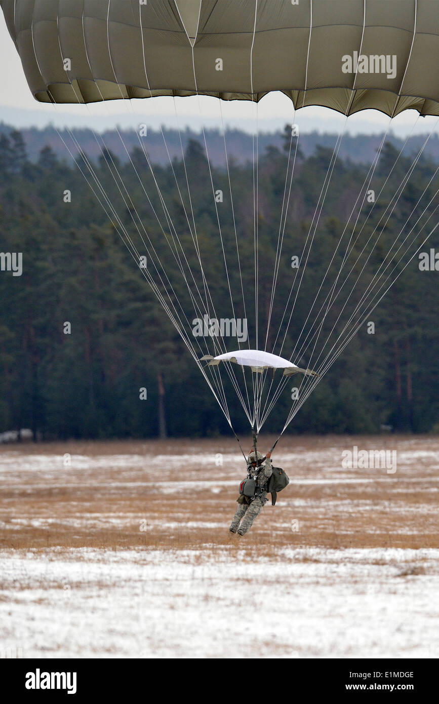 A U.S. Army Paratrooper assigned to 173rd Infantry Brigade Combat Team (Airborne) conducts a training jump from a CH-47 Chinook Stock Photo