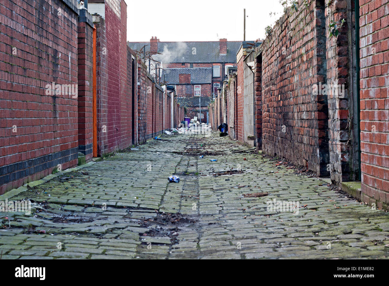 Household rubbish left lying about in a dirty back street cobble Stock ...