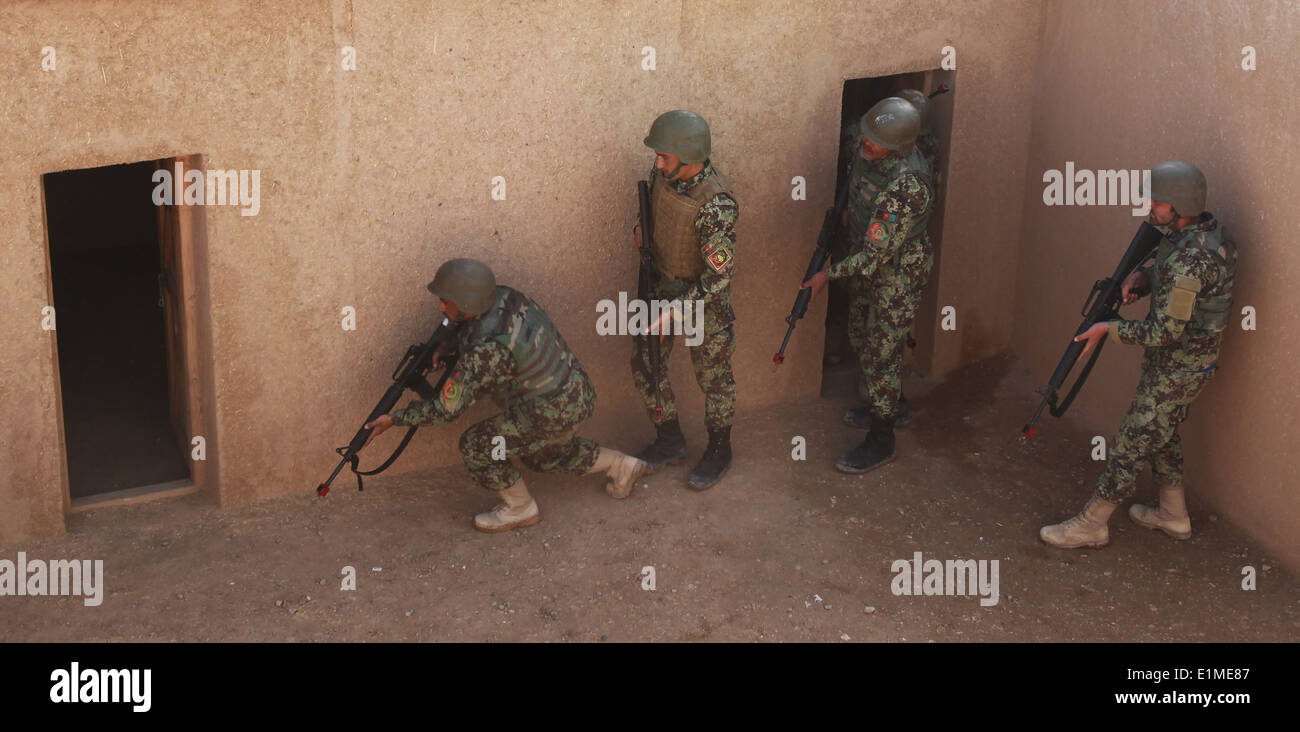 Afghan National Army soldiers with the 215th Corps enter a simulated enemy compound during a training course at the Regional Co Stock Photo