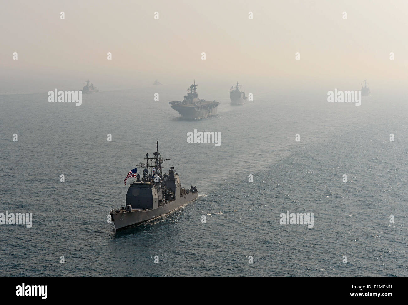 The guided missile cruiser USS Lake Erie (CG 70), front, transits the East China Sea with ships assigned to the Bonhomme Richar Stock Photo