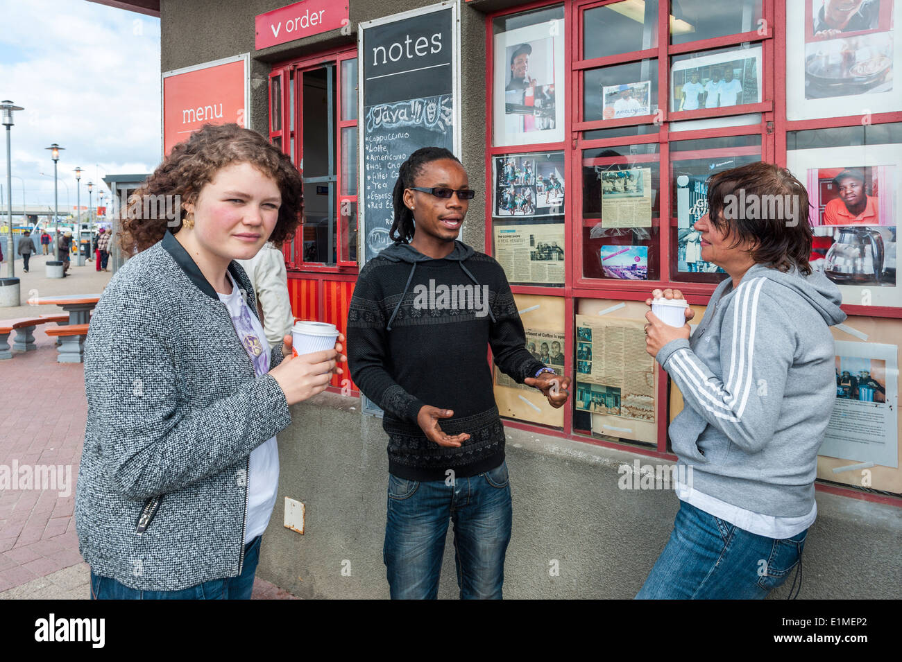 German students and township tour guide at a coffee shop in Khayelitsha, Cape Town, South Africa Stock Photo