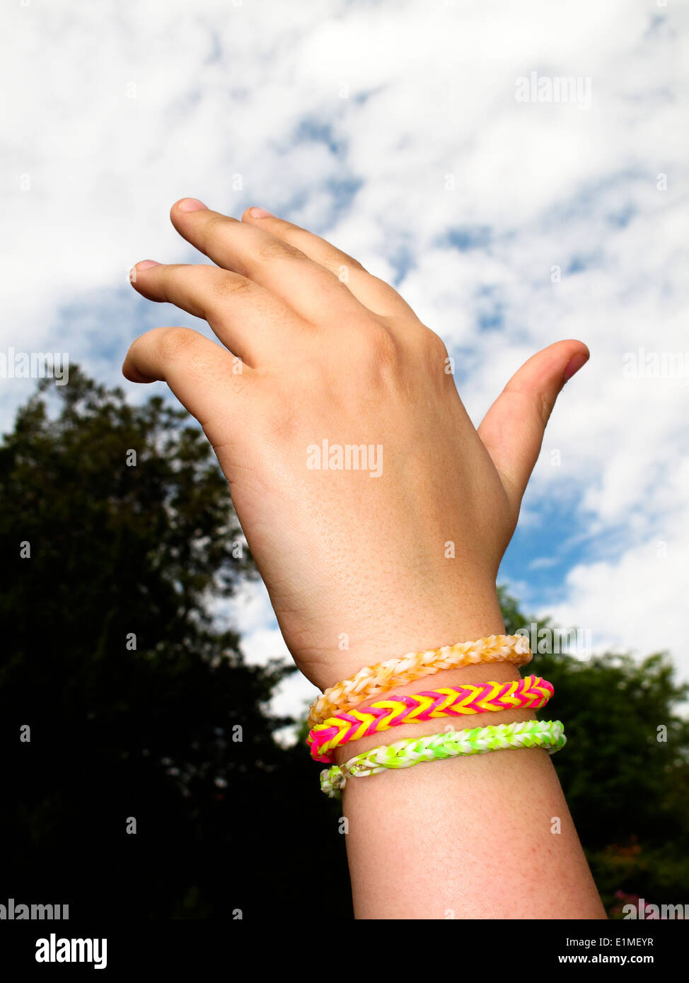 Rainbow loom bands bracelet on girl's wrist Stock Photo - Alamy