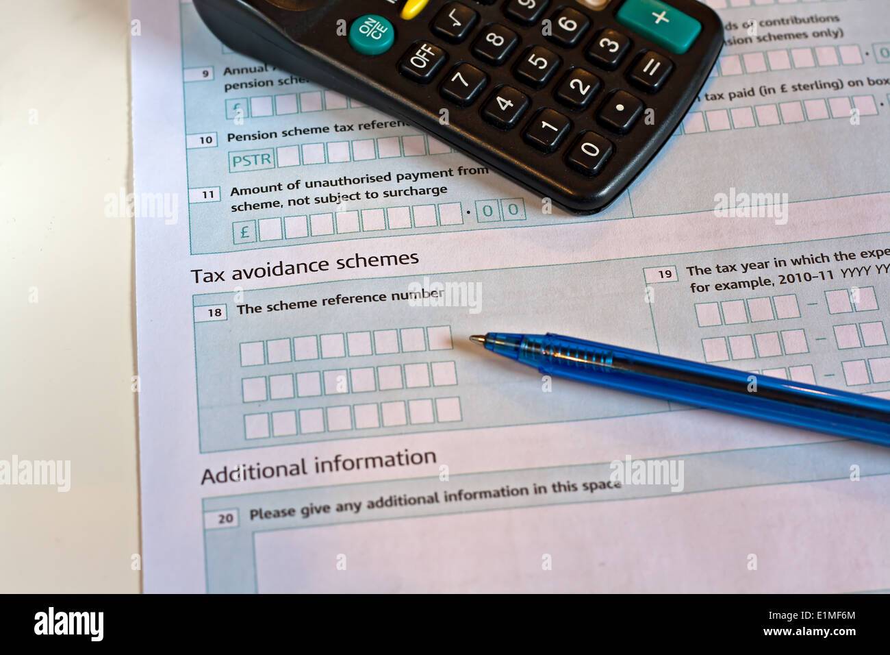 UK tax return, calculator and pen, (focus on the word Tax). Stock Photo