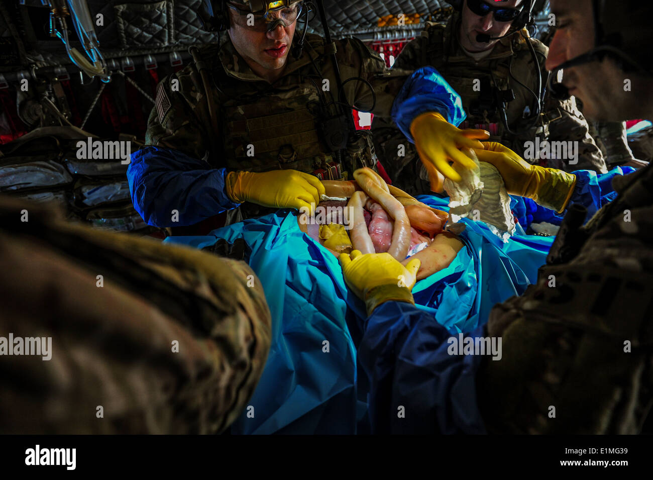 U.S. Air Force combat medics treat a simulated wound aboard an Army CH-47 Chinook helicopter during Emerald Warrior 14 at Hurlb Stock Photo