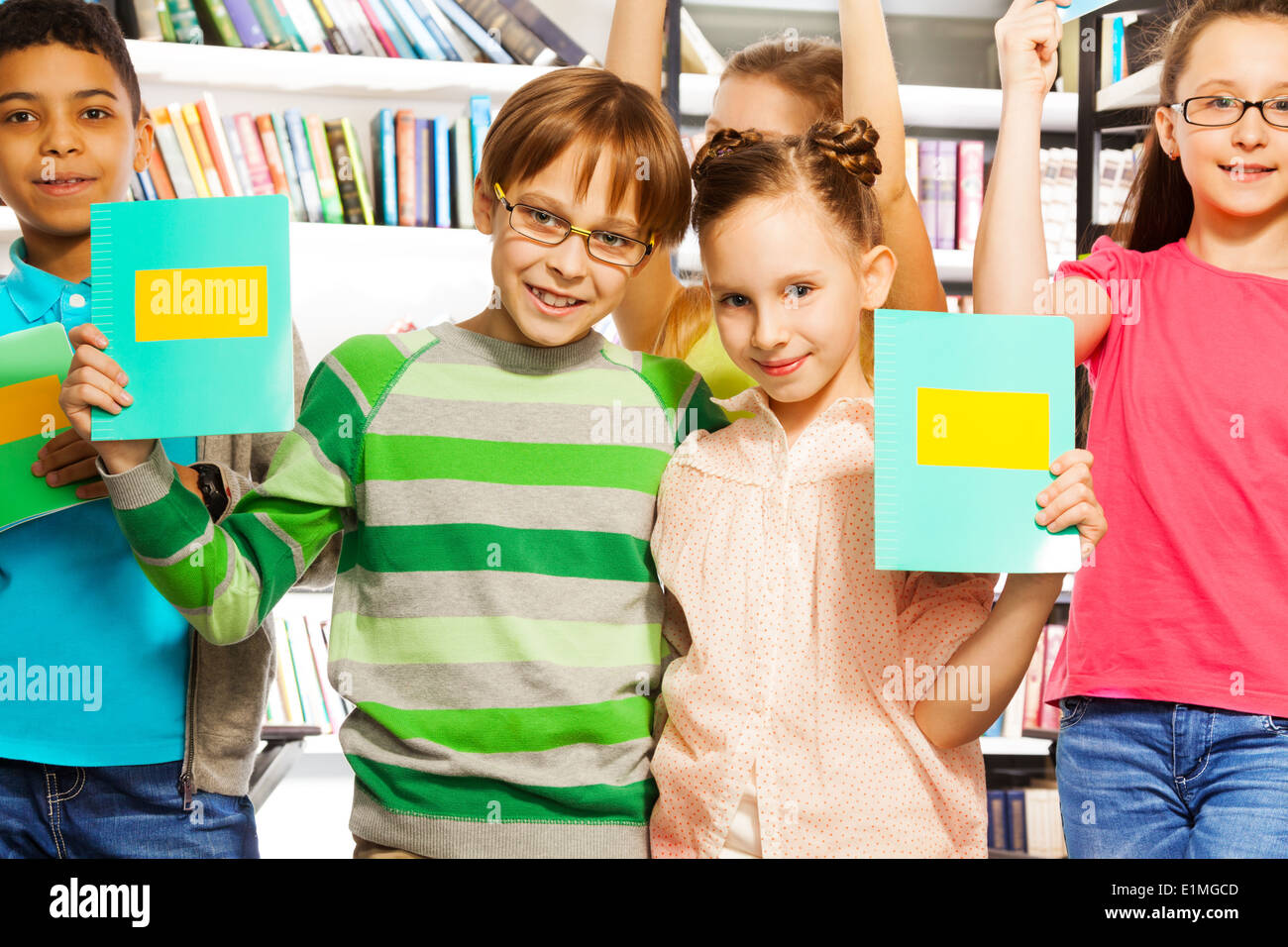 Boy girl holding book hands hi-res stock photography and images - Alamy