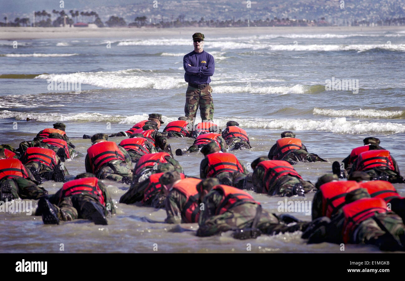 US Navy SEAL candidates during Hell Week surf drill part of the Basic Underwater Demolition/SEAL conditioning program April 15, 2003 in Coronado, California. Stock Photo