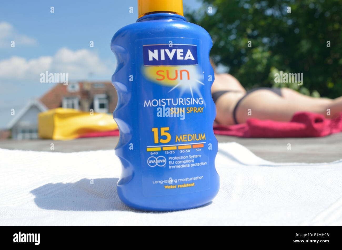 Nivea Suncream SPF 15 sunbathing woman in bikini Stock Photo