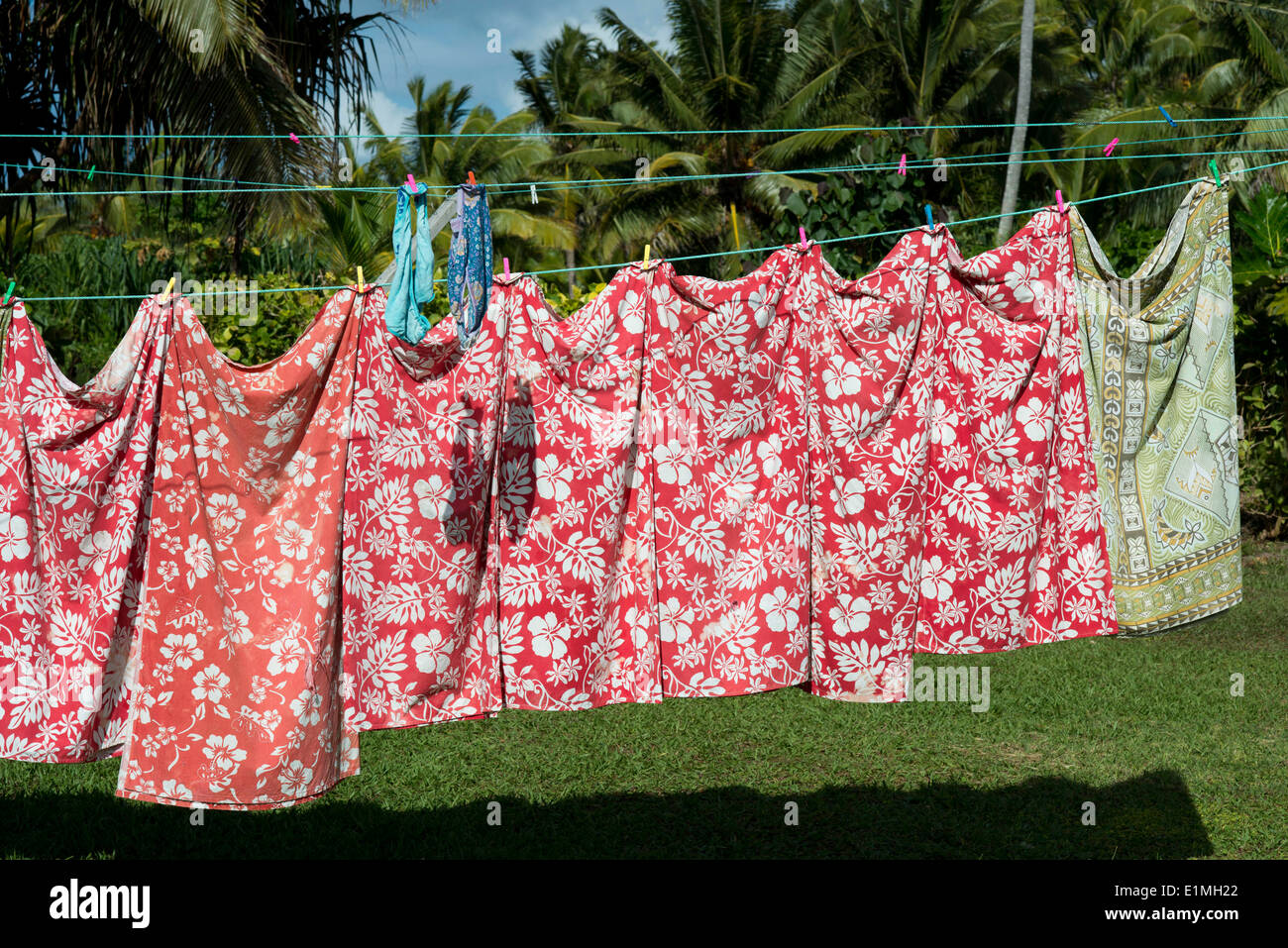 Typical Polynesian clothing lying. Aitutaki. Cook Island. Polynesia. South Pacific Ocean. Some tourists take pictures and take Stock Photo