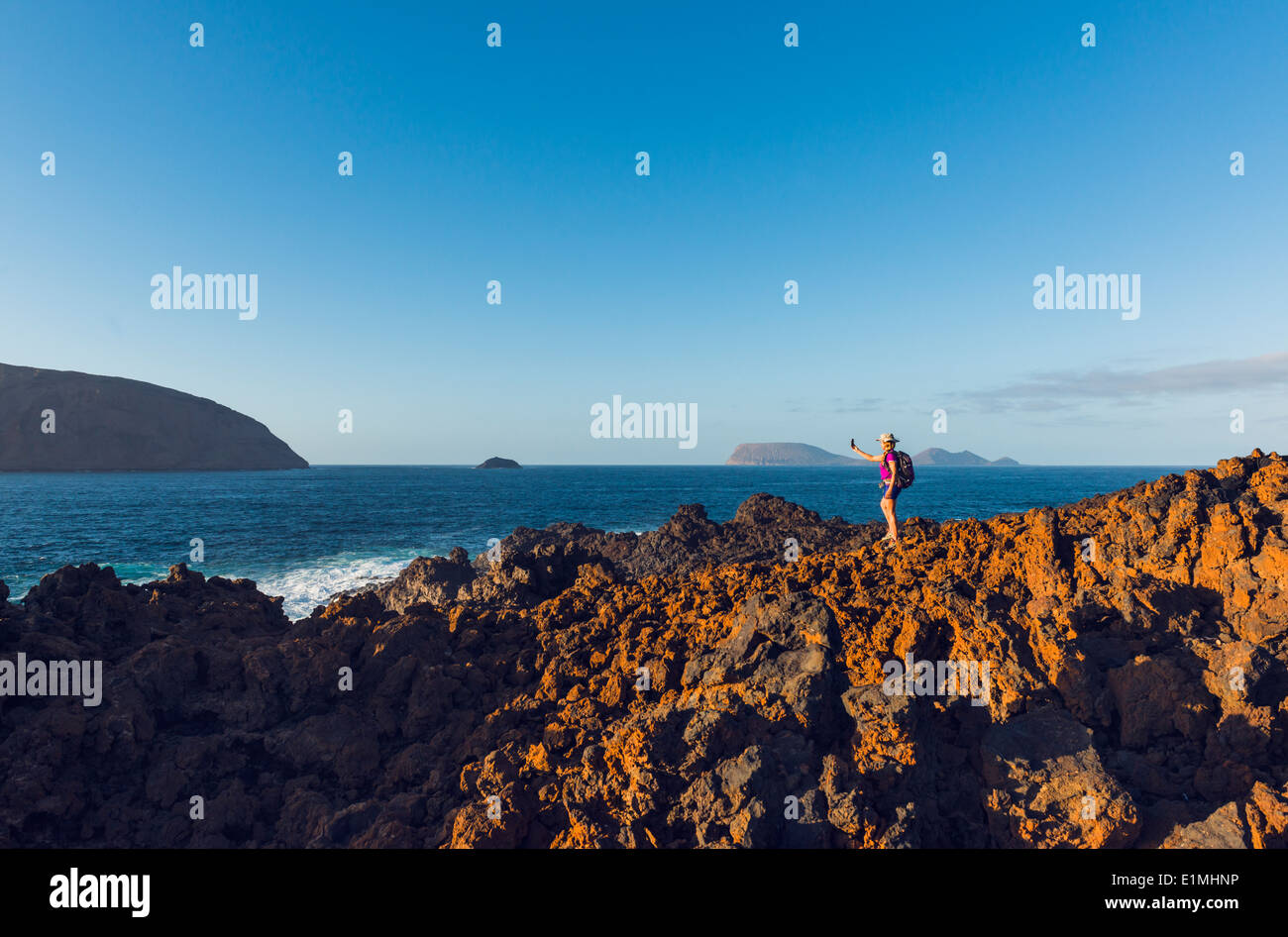 Woman hiking at La Graciosa Island, Lanzarote, Canary Islands, Lanzarote, Spain, Europe. Stock Photo