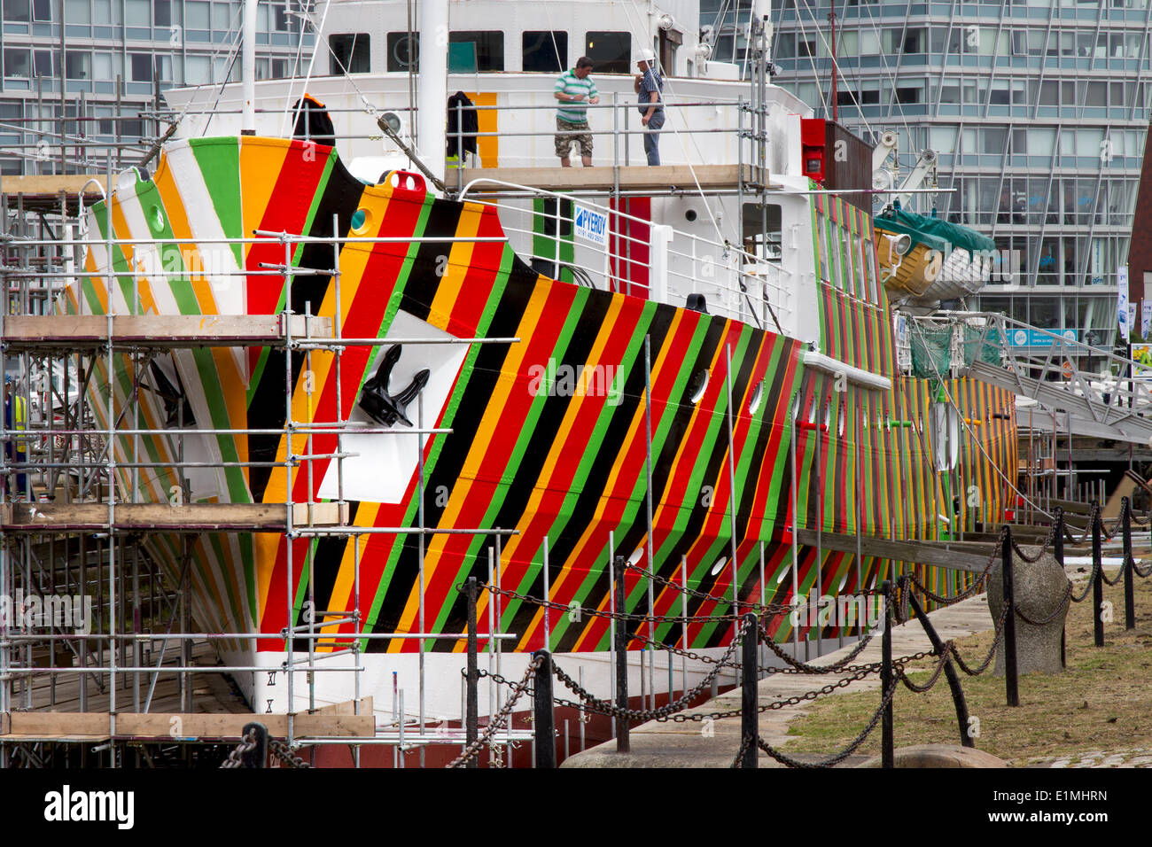 Liverpool pilot cutter number 2, 1953 the Edmund Gardner is being transformed by camouflaged red, black, orange & green stripes,‘razzle dazzle’ painted wartime design. Renowned biennial artist Carlos Cruz-Diez has been commissioned to work with  “dazzle” camouflage using an historic pilot ship owned and conserved by Merseyside Maritime Museum. The ship, which is situated in dry dock adjacent to Liverpool’s Albert Dock is being painted by the Cammell Laird team to realise the wartime design. Stock Photo