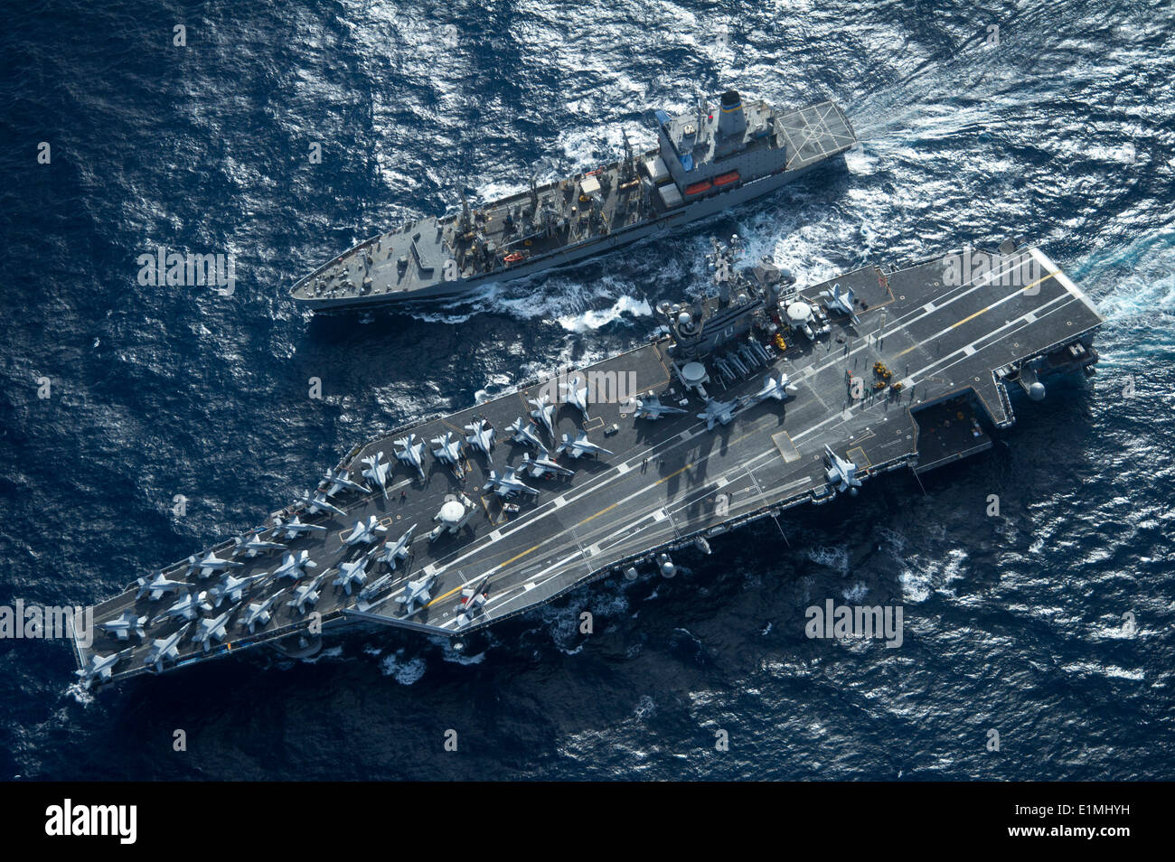 The aircraft carrier USS Carl Vinson (CVN 70) and the fleet replenishment oiler USNS Yukon (T-AO 202) conduct a replenishment a Stock Photo