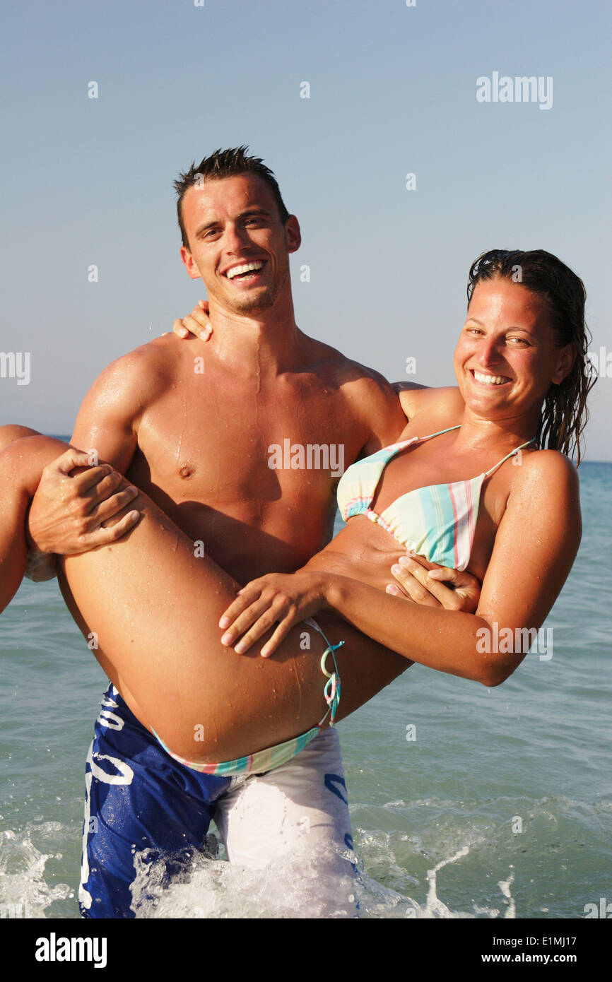 Happy couple on the beach, Ialyssos Bay, Rhodes Island, Greece Stock Photo