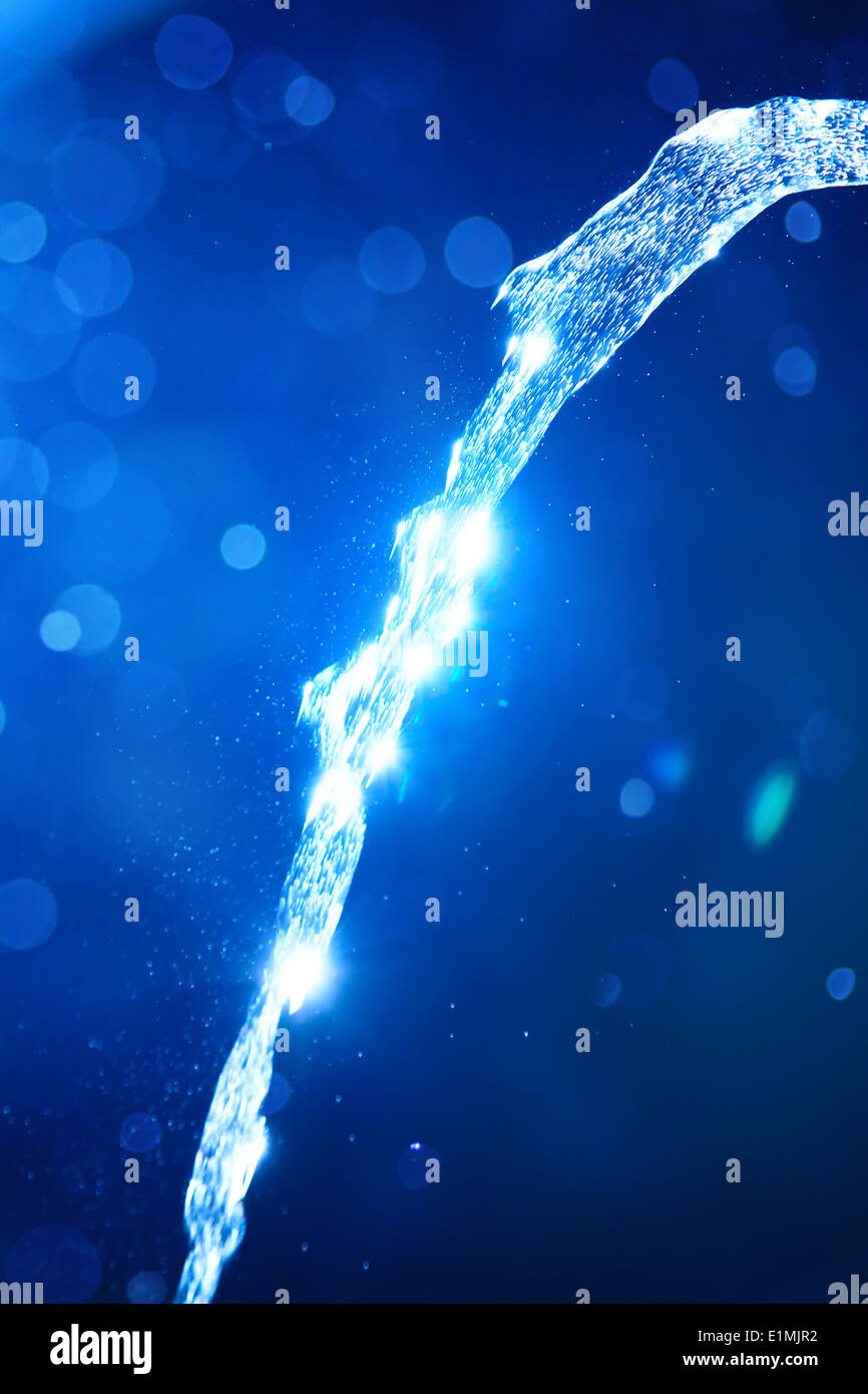 Pure water on blue background. Stock Photo