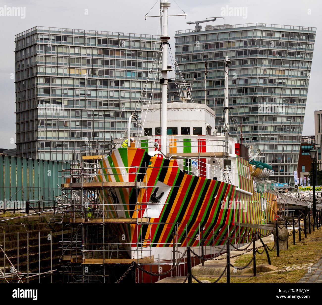 Liverpool pilot cutter number 2, 1953 the Edmund Gardner is being transformed by camouflaged red, black, orange & green stripes,‘razzle dazzle’ painted wartime design. Renowned biennial artist Carlos Cruz-Diez has been commissioned to work with  “dazzle” camouflage using an historic pilot ship owned and conserved by Merseyside Maritime Museum. The ship, which is situated in dry dock adjacent to Liverpool’s Albert Dock is being painted by the Cammell Laird team to realise the wartime design. Stock Photo