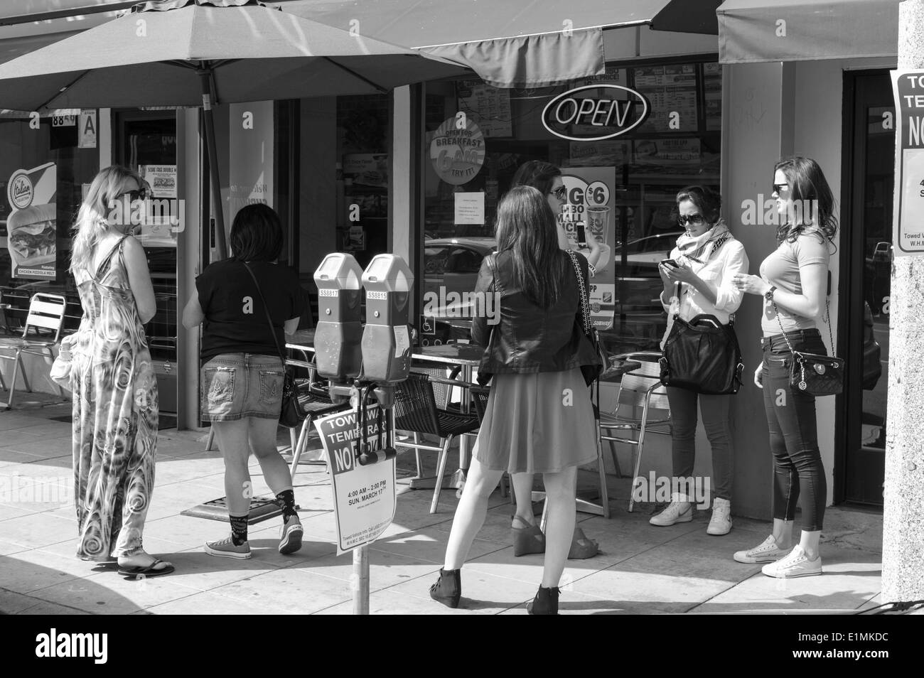 Women standing and talking on the street, Sunset Boulevard, Los Angeles, CA. Stock Photo
