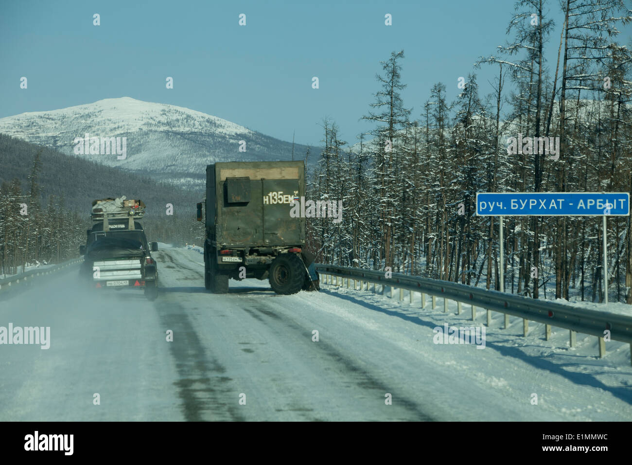 snowy mountains straight road truck Siberia 4wd Stock Photo