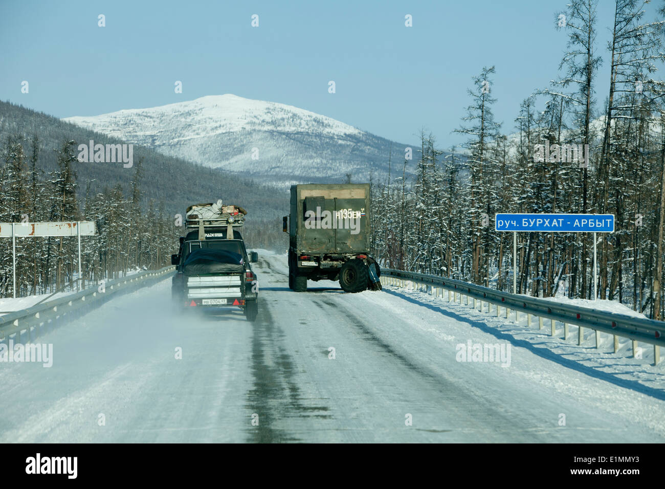 snowy mountains straight road truck Siberia 4wd Stock Photo