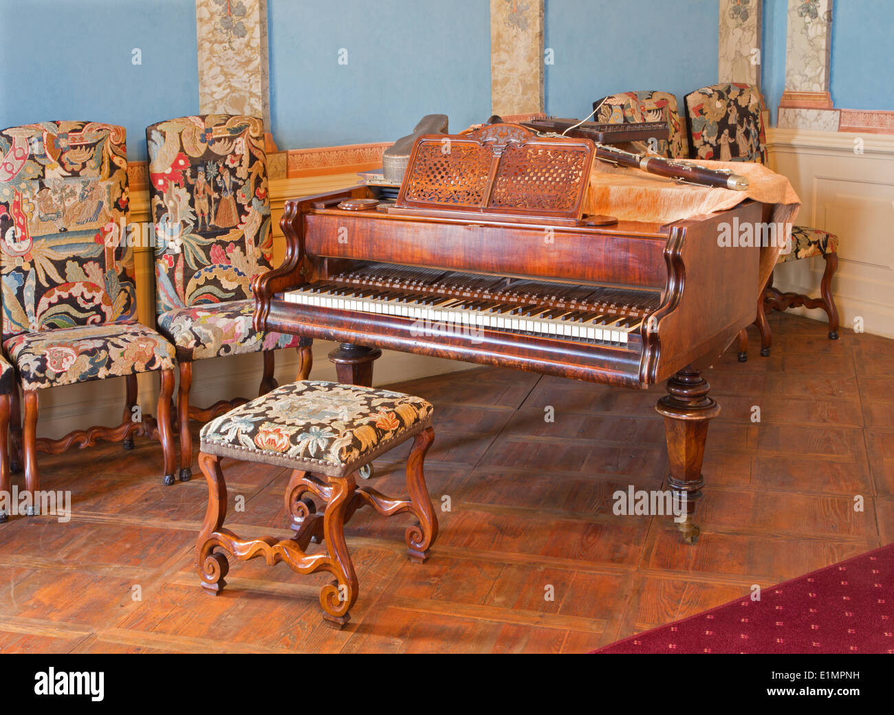 Piano in music saloon in palace Saint Anton with the handmade needlework on the chairs from 19. cent. Stock Photo