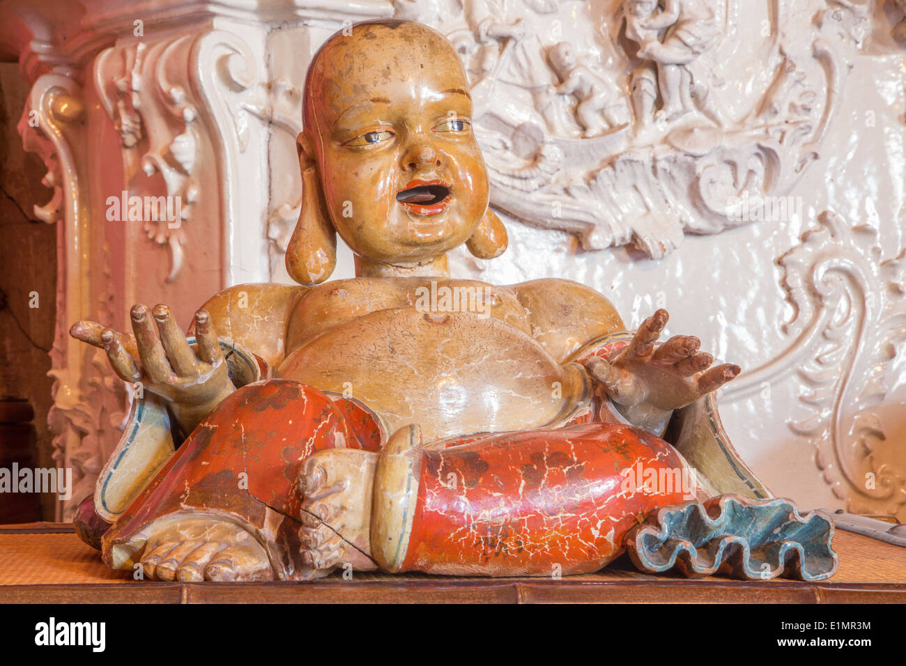 Wooden statue of supplicant as money box in the Chinese saloon from 19. cent. in palace Saint Anton. Stock Photo