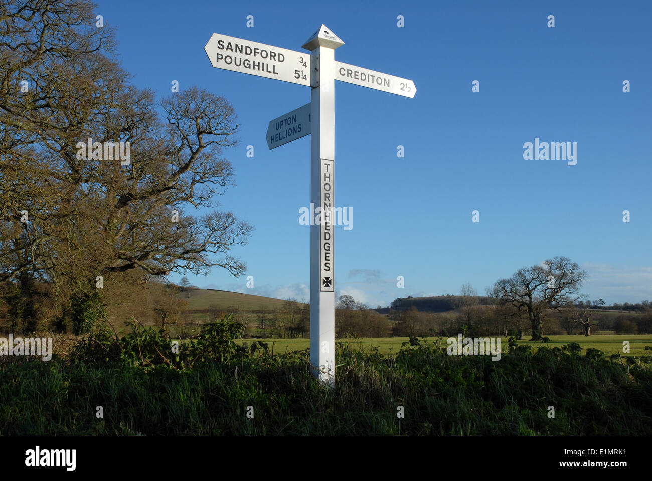Road sign for Sandford and Crediton, Devon, UK. Stock Photo