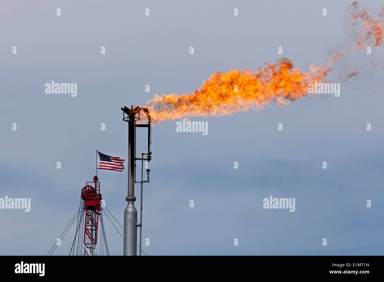 Epping, North Dakota - Natural gas is flared off as oil is pumped in the Bakken shale formation. The Stock Photo