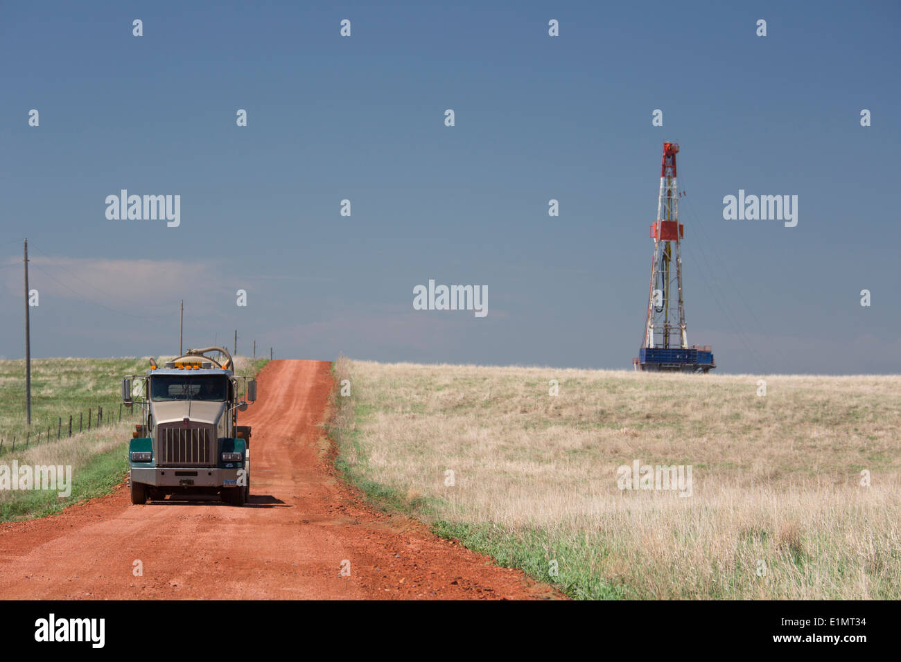 Belfield, North Dakota A truck on a road near a drilling rig Stock