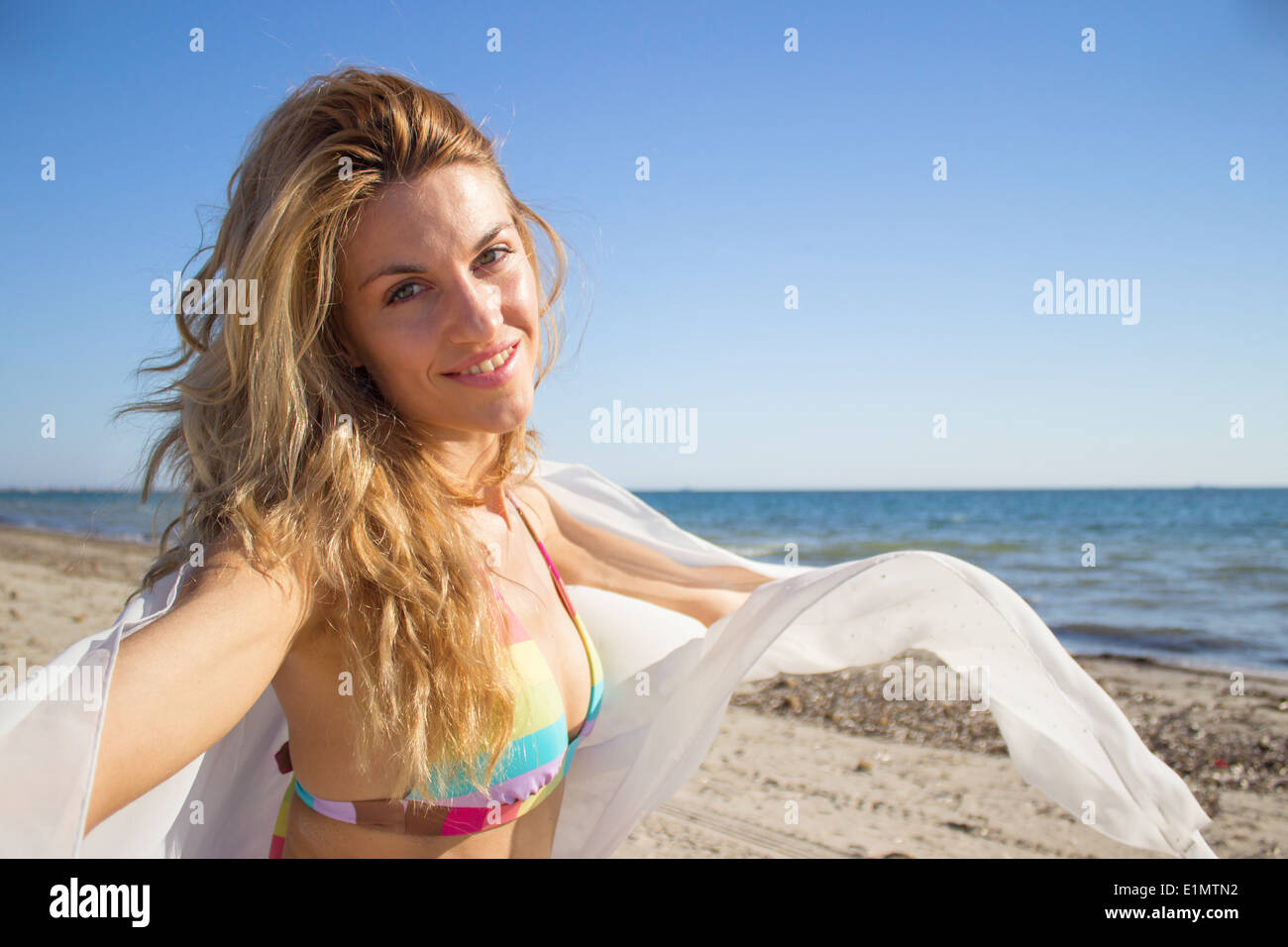 smiling young woman summer beach sea ocean white fabric Stock Photo