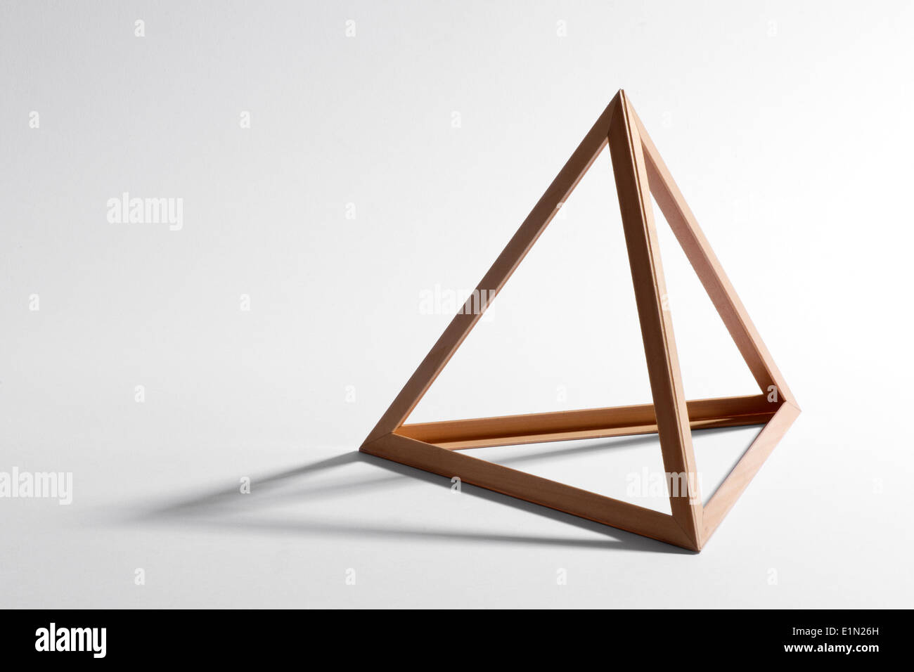 Open empty wooden triangular frame or pyramid shape Stock Photo