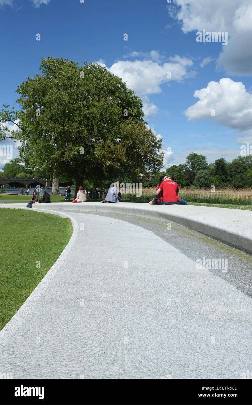 People enjoying the Princess Diana's fountain and memorial garden in Hyde Park London Stock Photo