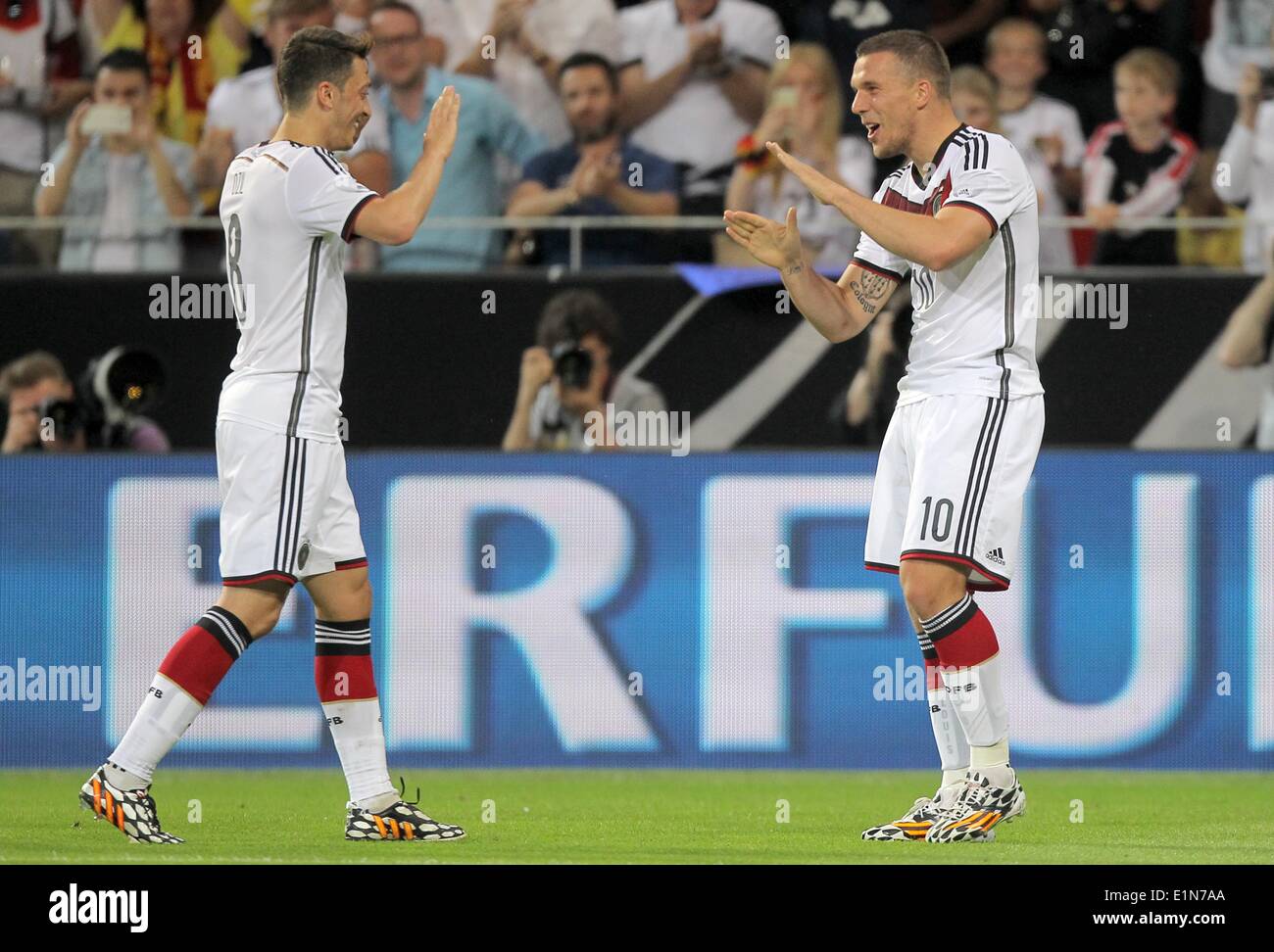 Mainz, Germany. 06th June, 2014. Germany's Lukas Podolski and Mesut Ozil in action during the international friendly match between Germany and Armenia at Coface Arena in Mainz, Germany, 06 June 2014. Photo: Fredrik von Erichsen/dpa/Alamy Live News Stock Photo