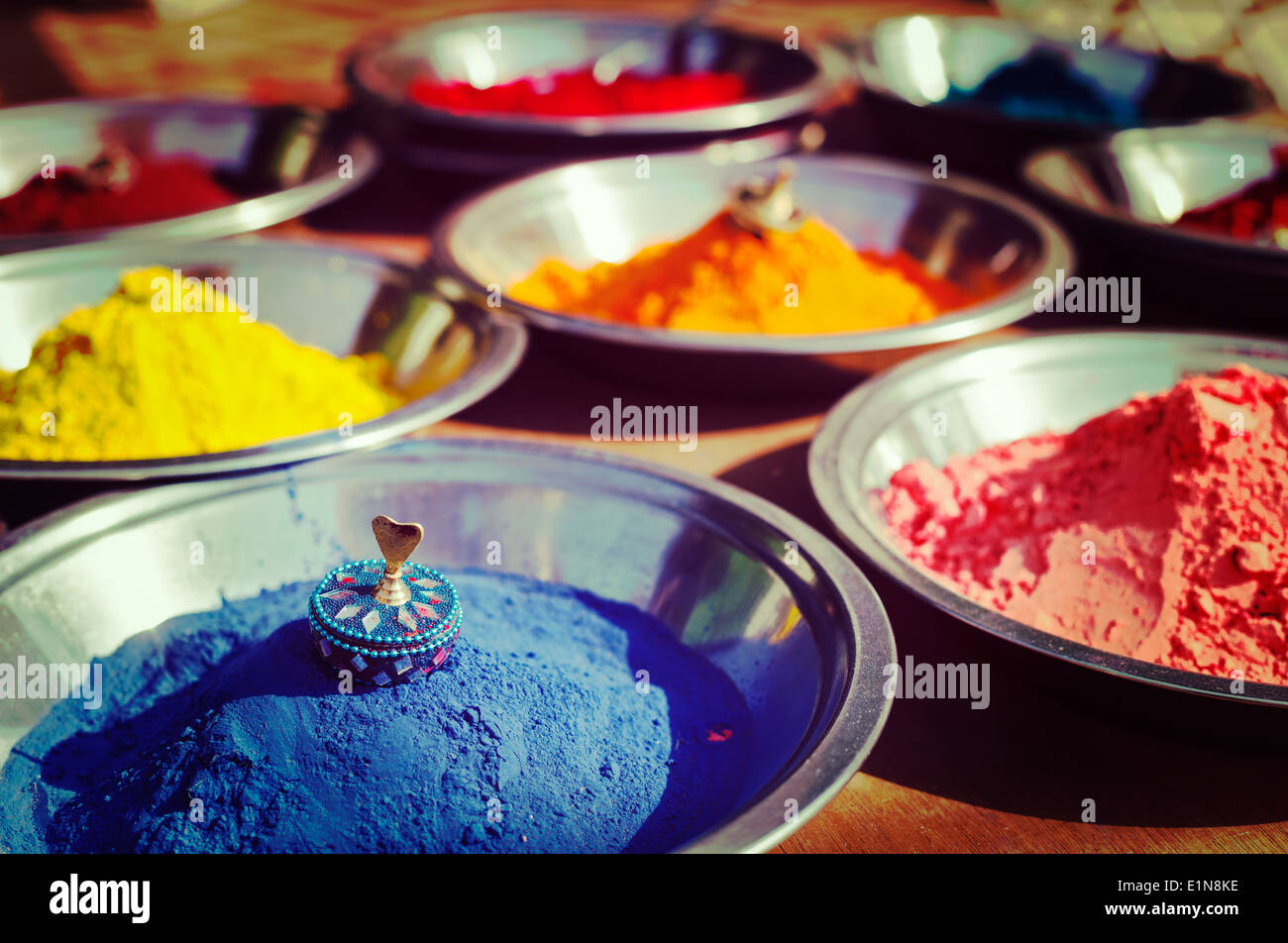 Vintage retro hipster style travel image of India symbol - Colored colorful powder kumkum in bowls on Indian bazaar for Holi Stock Photo
