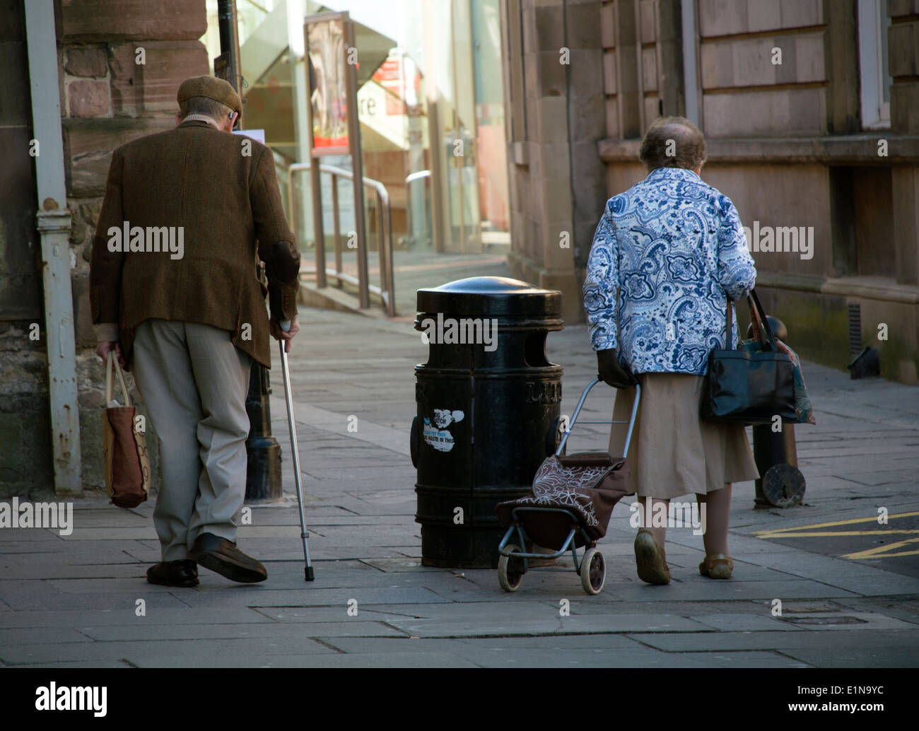 Elderly couple walking in town Stock Photo