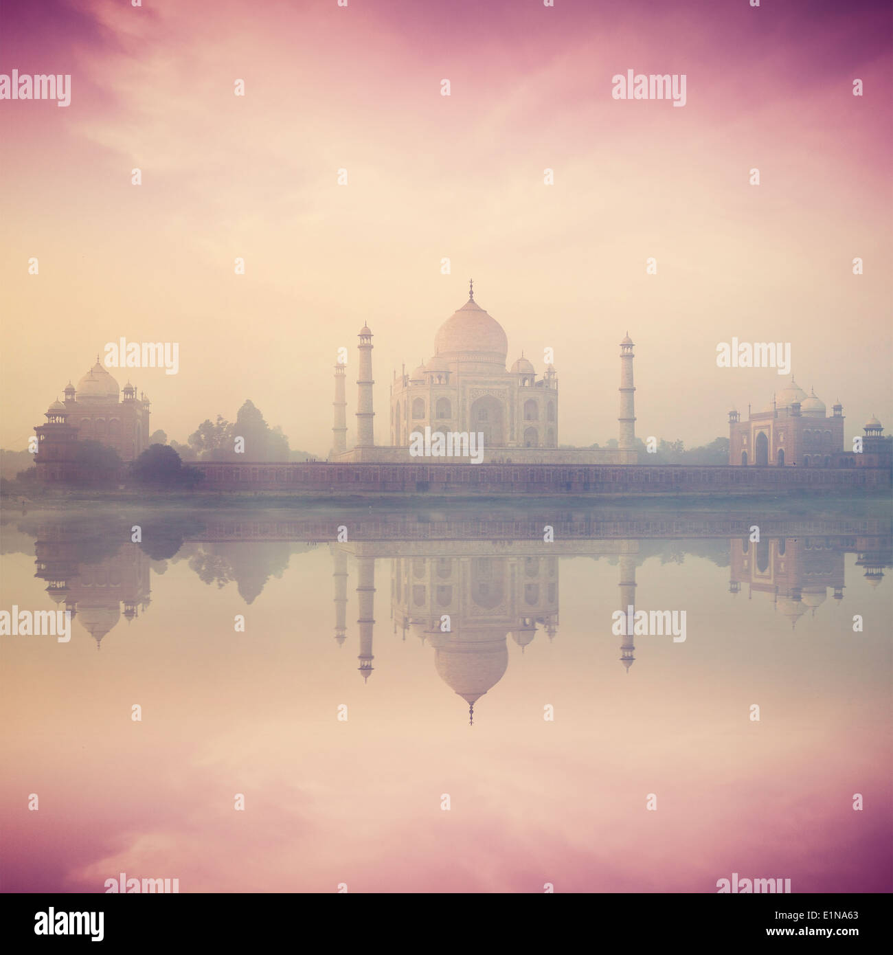 Vintage retro hipster style image of Taj Mahal on sunrise sunset reflection in Yamuna river panorama in fog, Indian Symbol Stock Photo