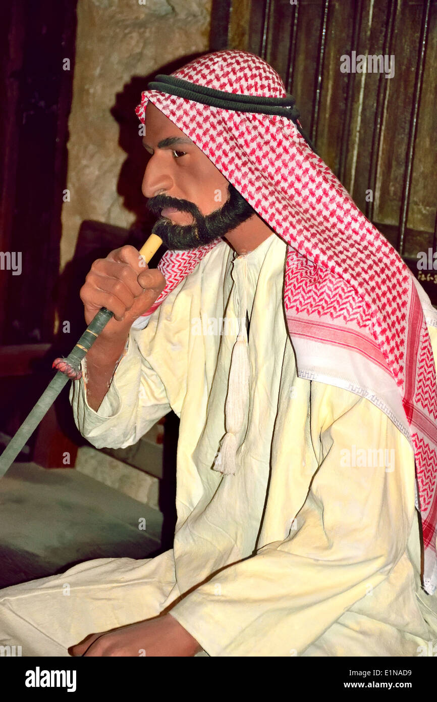 Arab smoking shisha, exhibit in Dubai Museum Stock Photo Alamy